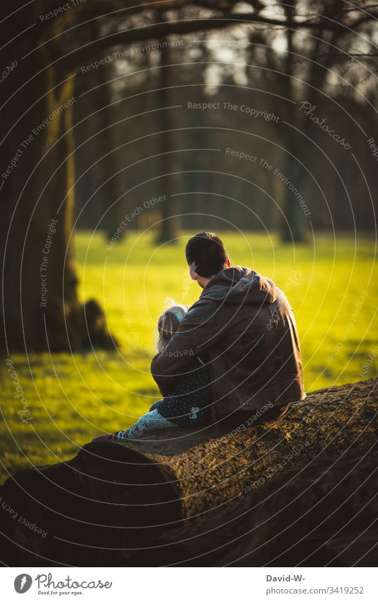 for each other as his father embraces child Father Child Love Family harmony Together Affection Sit Anonymous Trust Nature Spring Sunlight Daughter