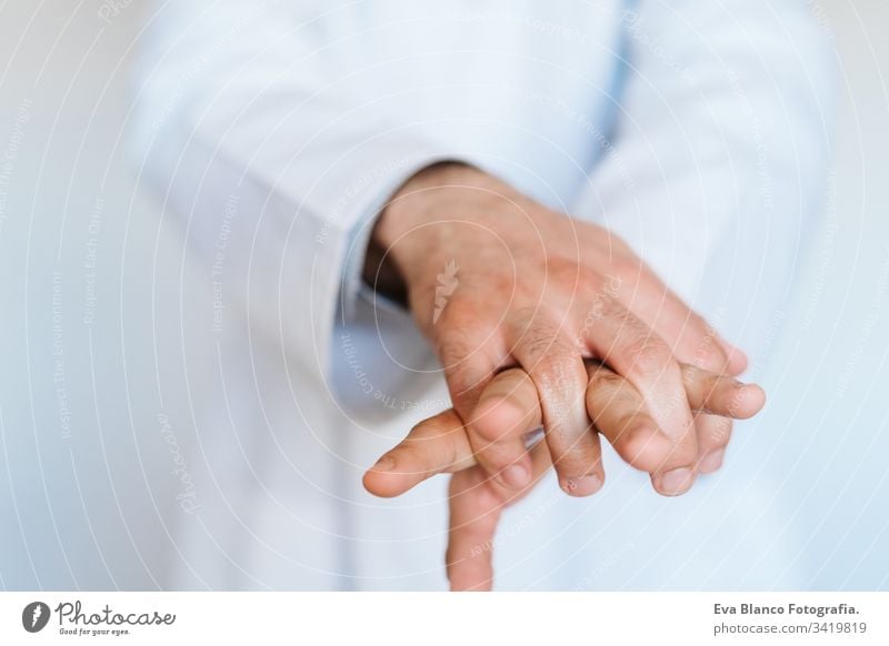 caucasian doctor wearing protective mask and gloves indoors. Using an alcohol gel or antibacterial disinfectant. Hygiene and corona virus concept man