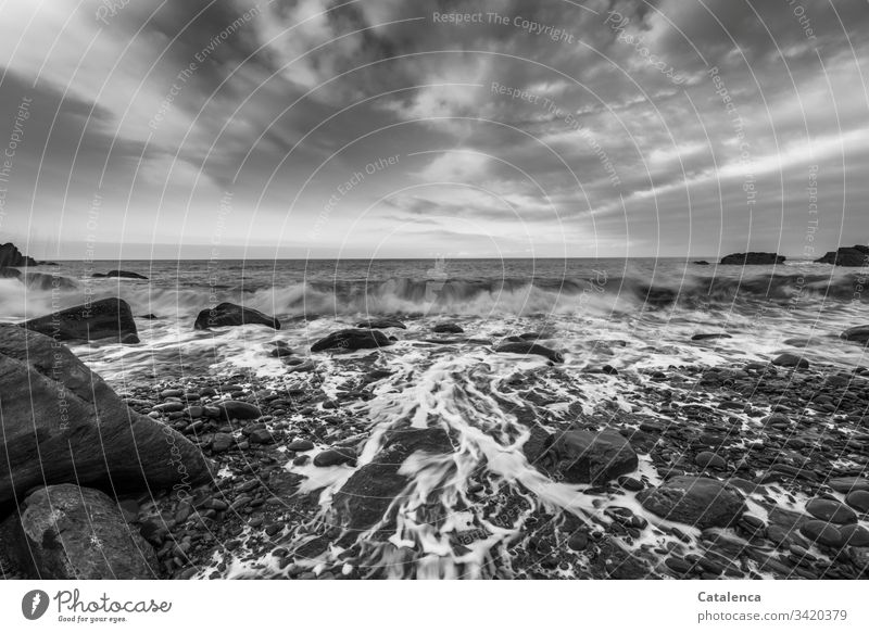 Waves break and wash the pebbles on the beach, clouds pass by, the view wanders to the horizon Beach Pebble Surf Ocean Wet stones Clouds Sky Horizon Nature