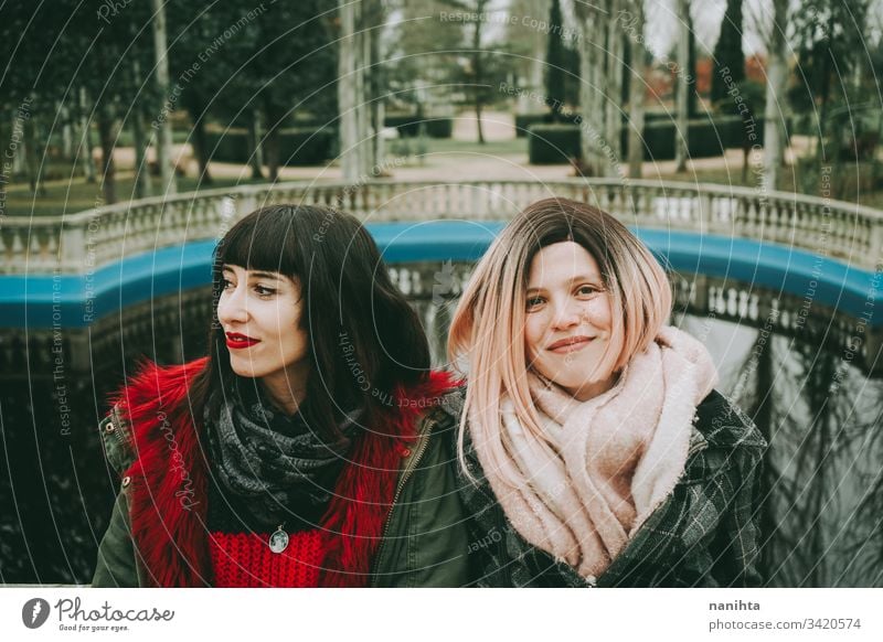 Two young and casual women spending time together friends trendy youth friendship two urban outdoors funny enjoy life lifestyle youthful fresh real candid
