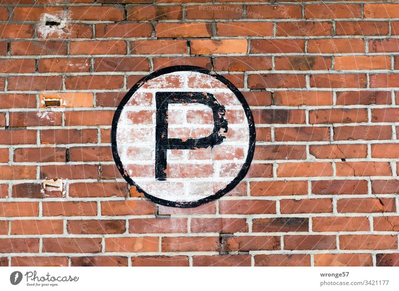 Large black P on white background on a brick wall Letters (alphabet) Colour photo Day Characters Exterior shot Capital letter sign Brick wall Building