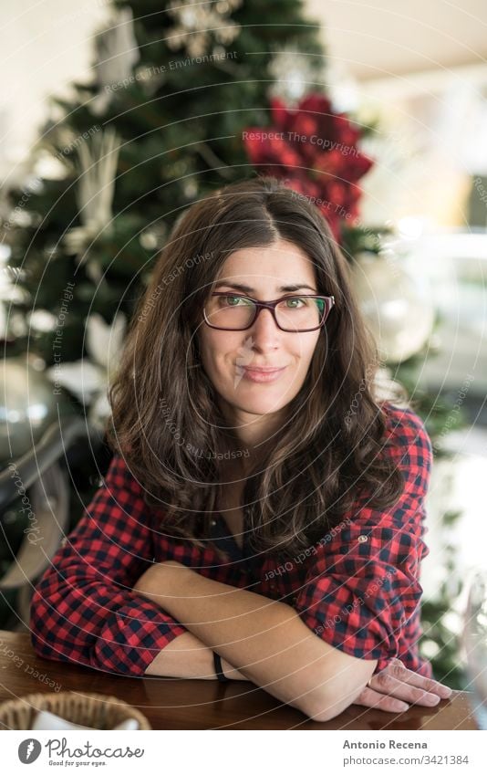 Pretty woman with glasses portrait with christmas tree in background woman portrait home 30s 40s attractive caucasian spanish one person one woman only people