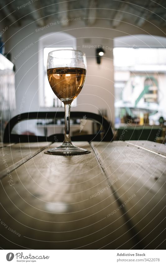 Glass of wine on wooden table glass rustic wineglass drink alcohol bar restaurant beverage liquid pub transparent tradition glassware golden counter service