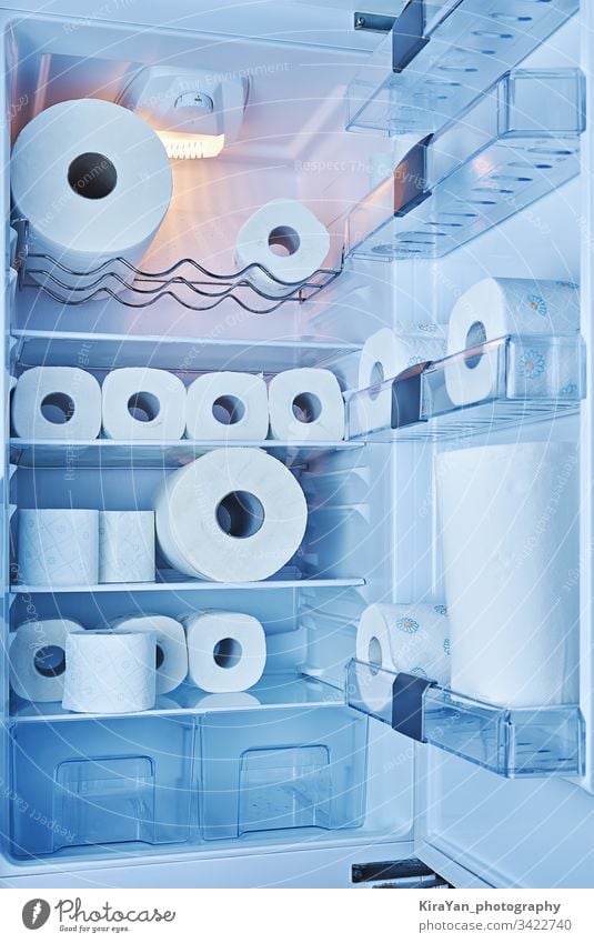 Fully filled toilet paper fridge. Panic buying toilet paper in all countries during spread of COVID-19 coronavirus covid-19 refrigerator kitchen household prank