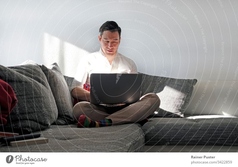 Man works from home with a laptop in the living room more adult Easygoing Computer Copy Space Entrepreneur freelancers Home Home office indoors Manly