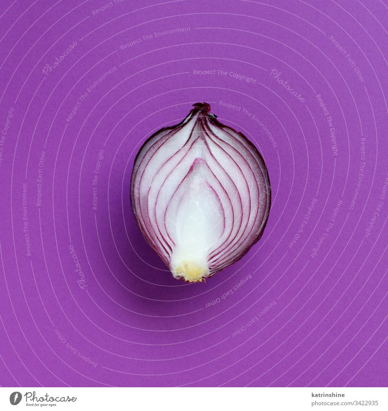 Purple onion on a purple background violet top view above red sliced half food healthy monochrome raw organic vegetable ingredient vegetarian ripe vitamin