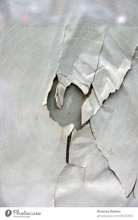 paper with hole behind glass pane Paper Wrapping paper Torn Crack & Rip & Tear cracks Broken Hollow Slice Window Shop window reflection structure texture