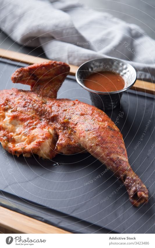 Fried chicken leg and wig near sauce a Royalty Free Stock Photo