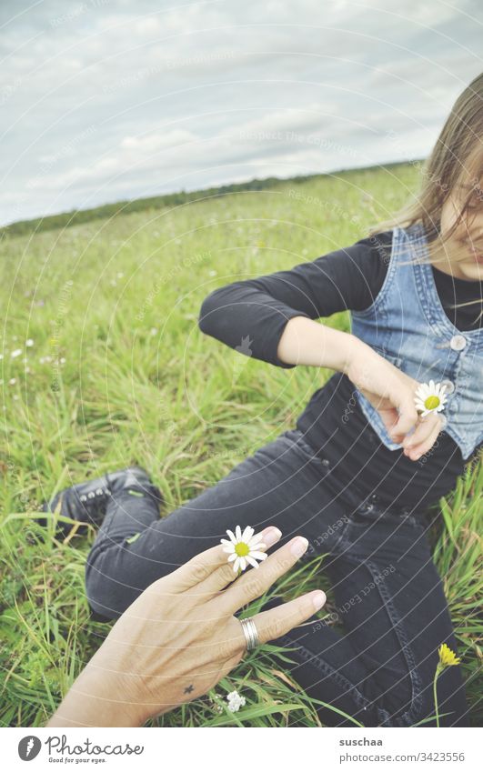 mother and daughter in green with ring of flowers Child Girl hands Hand Fingers Infancy Exterior shot Playing out Leisure and hobbies Spring Nature Ring Flower