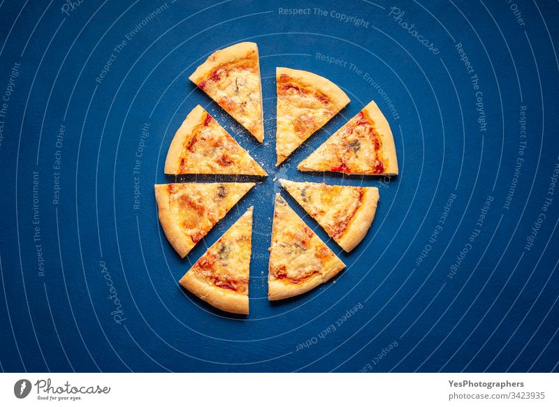 Sliced pizza on blue background. 4 cheese pizza slices Italian above view carbohydrates carbs classic blue crust cuisine dinner european famous fast food