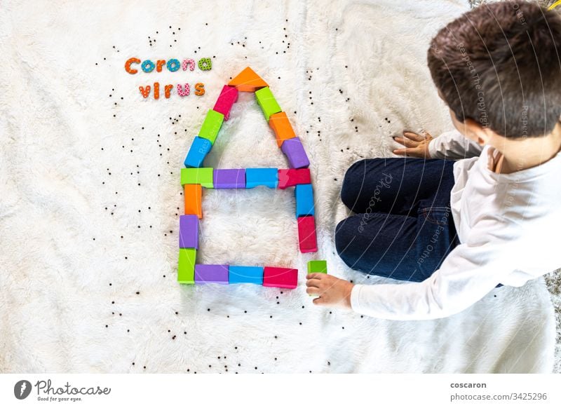Little kid playing and understanding wath the coronavirus is blocks caucasian child children city concept confined confinement contagious copy space covid19