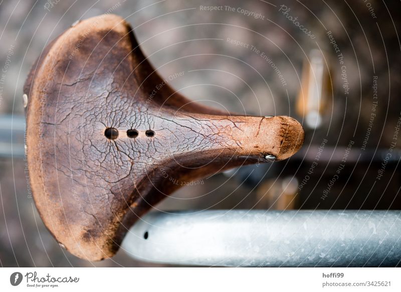 old leather saddle with traces of time from above Saddle Bicycle Bicycle fittings Bicycle saddle Leather Old Patina Shallow depth of field Rust Brown Retro