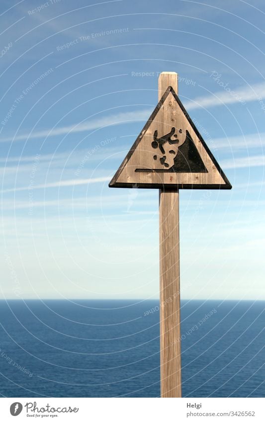 Warning sign "Falling hazard" made of wood on a steep coast on Mallorca Signs and labeling Colour photo Characters Exterior shot Deserted Day Copy Space left
