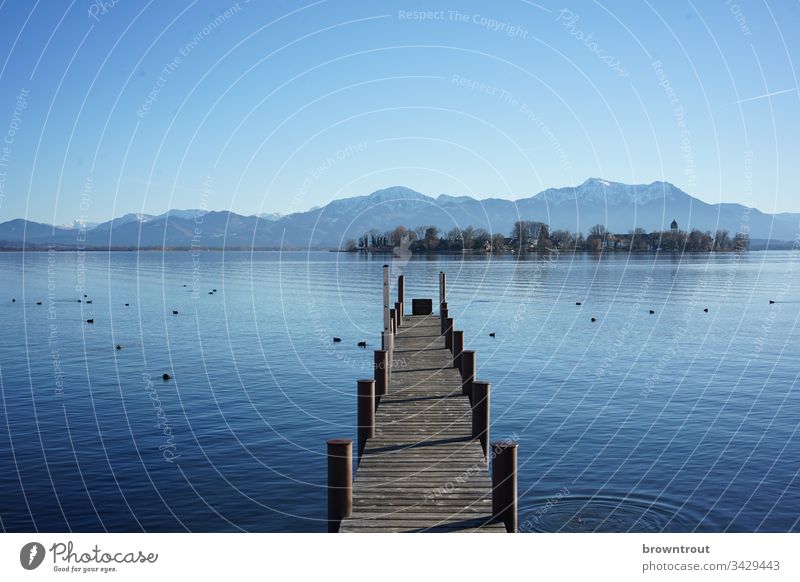 Boat landing stage at the Chiemsee with view of the Fraueninsel. Footbridge Lake Water Wood Blue Alps Island Mountain Blue sky Lake Chiemsee Gstadt
