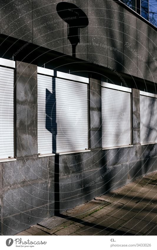 windows with closed roller shutter Architecture architectural photography Part of a building Building Facade Light Shadow Window Exterior shot Colour photo