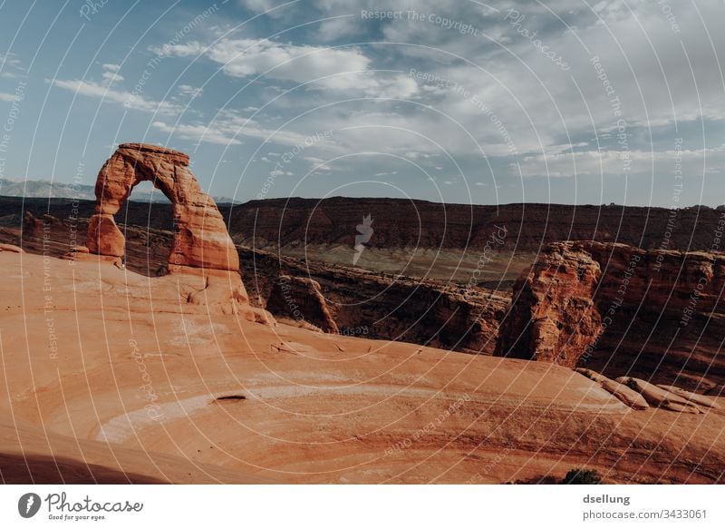 Delicate Arch in setting sun Wide angle Shadow Evening Copy Space top Exterior shot Colour photo Graceful Arches National Park Yellow Brown Famousness Blue