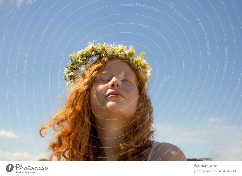 Red-haired young woman with wreath of flowers Flower wreath blossoms Happy Curl Margariths portrait Landscape format Contentment Closed eyes Sky Young woman