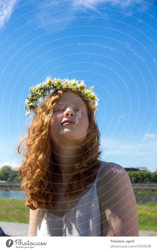 redheaded woman with wreath of flowers in her hair Flower wreath Sun relaxation Margariths tranquillity Summer daylight To enjoy Young woman