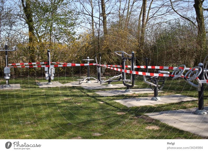 Sports equipment in the park is shut down and wrapped in barrier tape to prevent infection with the corona virus Park Fitness Barred Sports Training