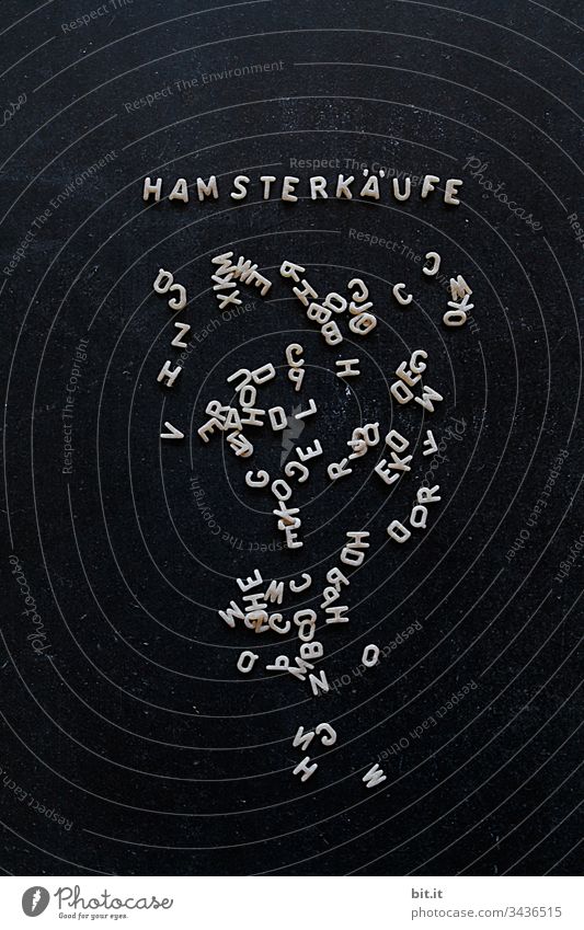 Letter noodles on a black board with writing, hamster purchases, as a reference to selfishness, ruthlessness and greed. covid-19 risk of contagion Sterile