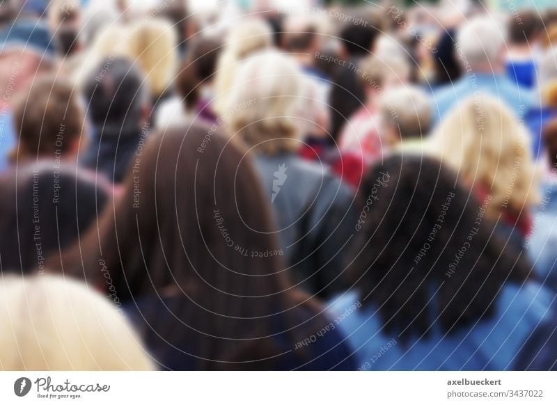 blurred crowd of people blurry group crowded public mass audience back behind rear head spectator pedestrian men women many anonymous unrecognizable outdoor