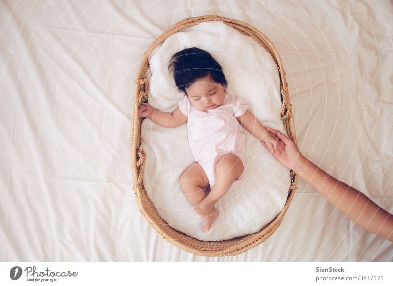 Baby sleeping in a basket a Royalty Free Stock Photo from Photocase