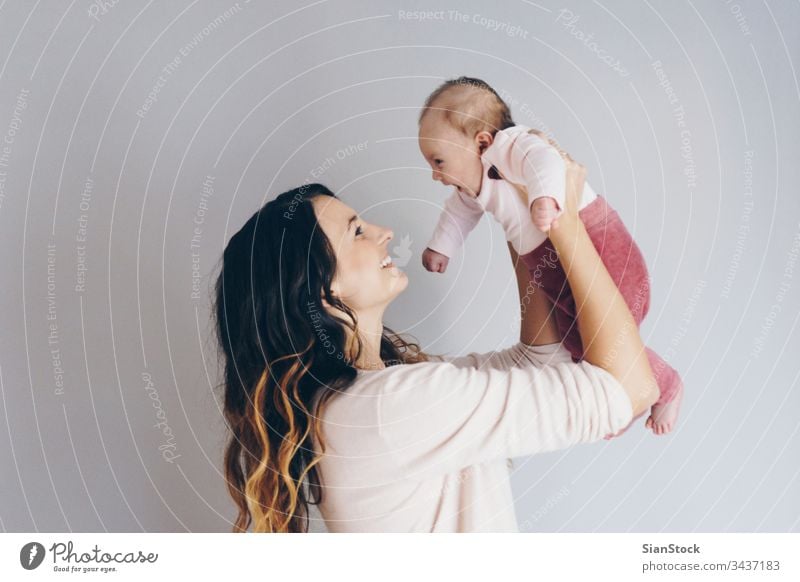 Picture of happy mother playing with her baby mom family kid child beautiful happiness young love daughter little white cute healthy girl woman adorable parent