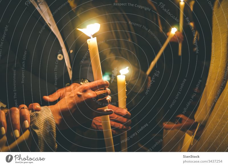 Woman holding a candle at night, during the Easter celebrations easter church candles orthodox religion christian light people prayer fire dark flame woman