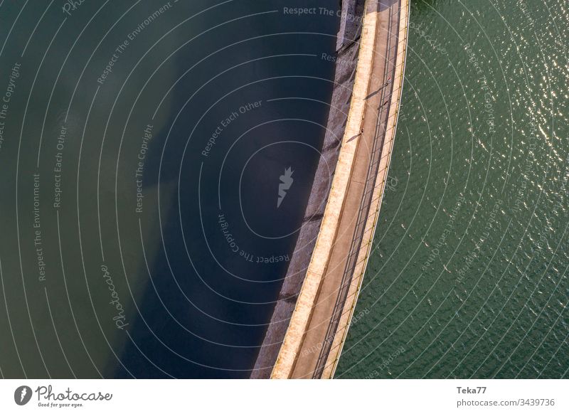 water dam from above big dam stone dam drinking water dam dam structure see dam wave lake waves wave texture aerial view background blue sun sunny drink water