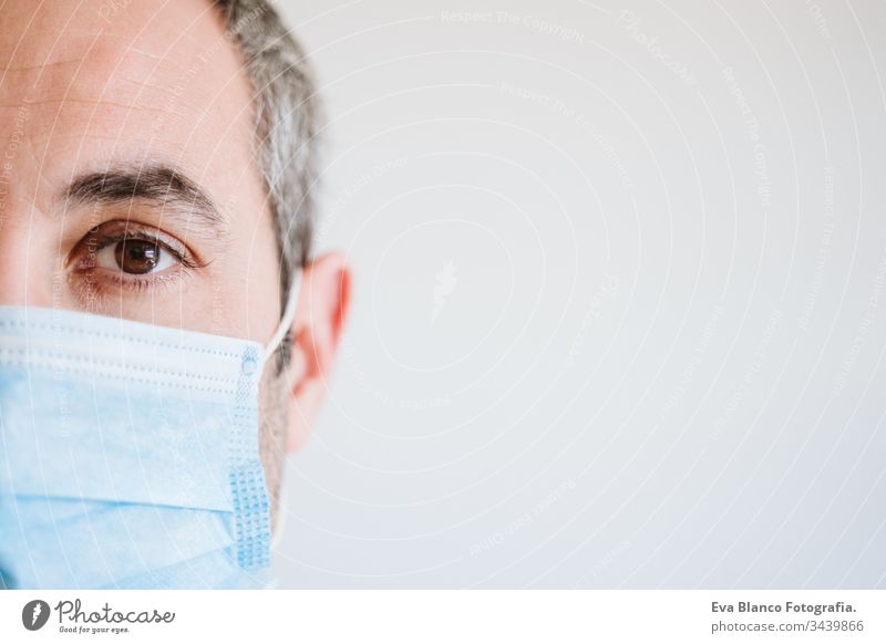 close up view of doctor man wearing protective mask and gloves indoors. Corona virus Covid-19 concept portrait professional corona virus hospital working