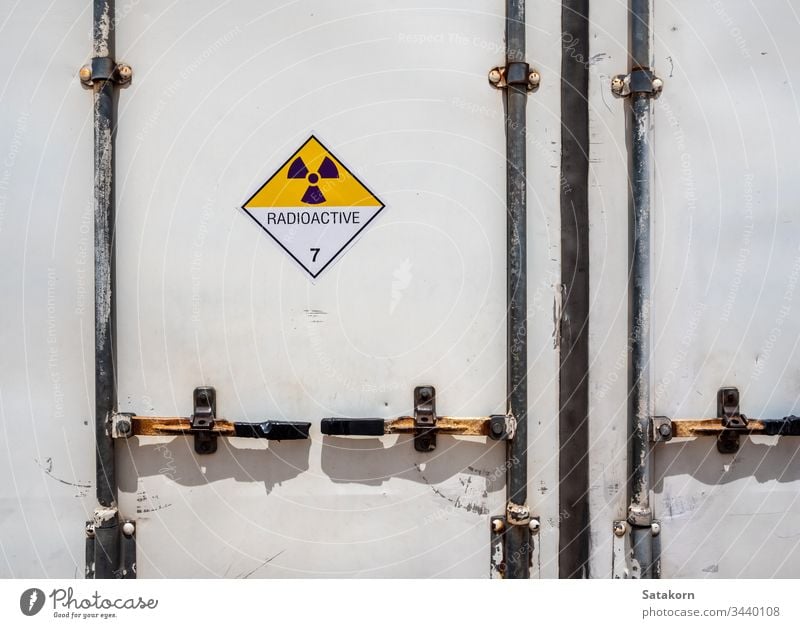 Radiation warning sign on the Dangerous goods transport label Class 7 at the container of transport truck hazmat radioactive transportation symbol aluminium