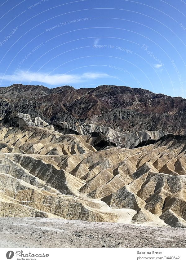 Desert landscape in Death Valley USA dead Dry Hill hilly Sky Blue sky panorama Landscape Nature Brown tan Sand Clouds road trip vacation holiday beautiful