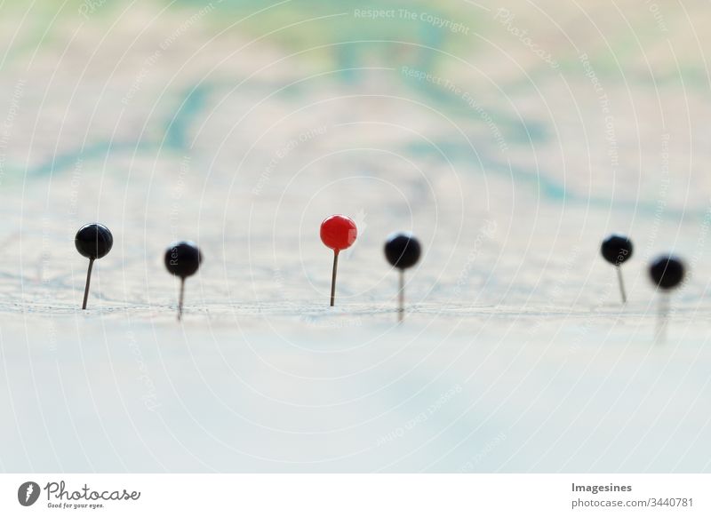 Close up of pins on a map. Travel to, destination. Pins mark position on the map. Map navigation with red and black markers. Places on map background. Close-up