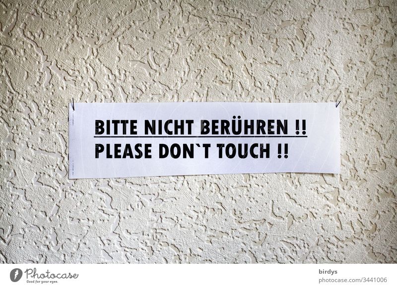 Please do not touch, improvised sign . Protection against infection. Protection against damage. Protection against contamination during a pandemic like Covid19, Corona. Writing, notice in German and English language.epidemic protection
