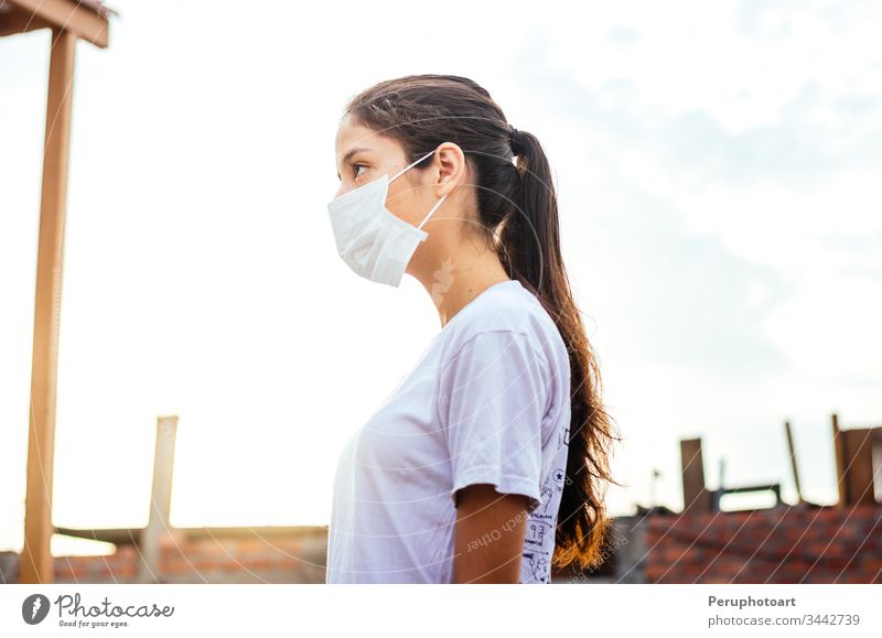 Young woman with a mask for protection against coronavirus COVID-19 on a sunny day young infection epidemic covid-19 adult illness female face portrait people