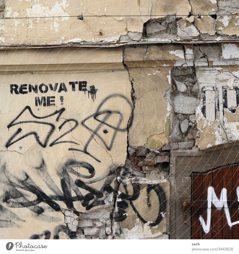 dilapidated facade of a house with the inscription "Renovate me". Past Redecorate Wall (barrier) Wall (building) Colour photo Transience Destruction Broken Old