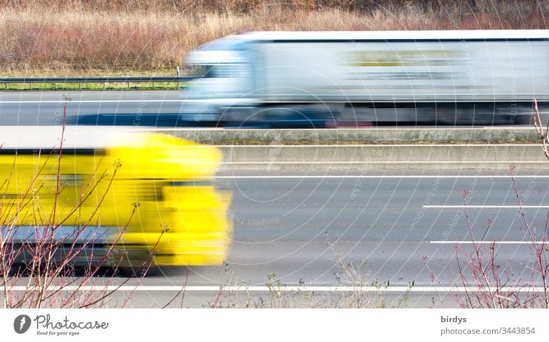 Driving trucks on a motorway, motion blur, logistics, supplying the population with everyday necessities lorry lorries motor vehicle Logistics Truck