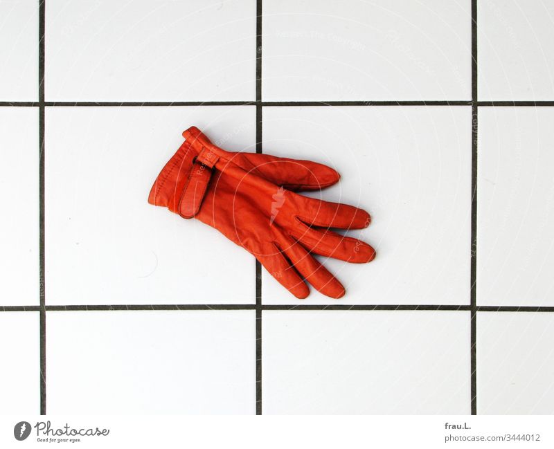 The orange glove froze on the cold tiles and he longed for his partner. bathroom floor Leather Interior shot Day Tile Deserted Living or residing