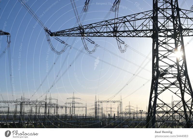 Transformer station under a clear sky Electricity high voltage High voltage power line transformer station Back-light Industry Cable energetic renewable