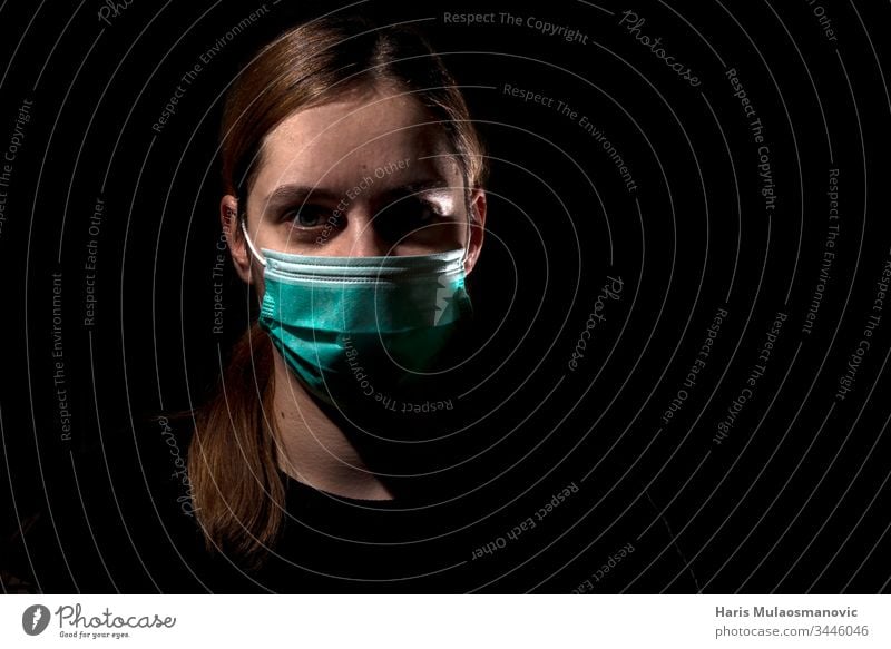 Woman with medical mask for protection of corona virus covid-19 SARS-CoV-2, woman with mask on black background 30s adult apocalyptic caucasian color
