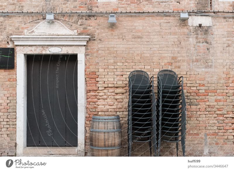 stacked chairs with wine barrel and historical facade Stack Brick Brick wall Keg Wine cask Old town Closed Chair Group of chairs Stack of chairs Minimalistic