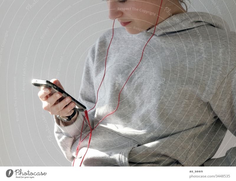 Hand with mobile Cellphone Headphones Telephone Mobile Human being Youth (Young adults) using Easygoing Technology Lifestyle Communication stop use Mobile Home