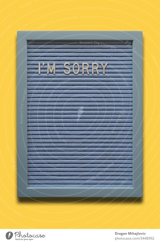 Light blue message board I`m sorry on the yellow background - a Royalty  Free Stock Photo from Photocase