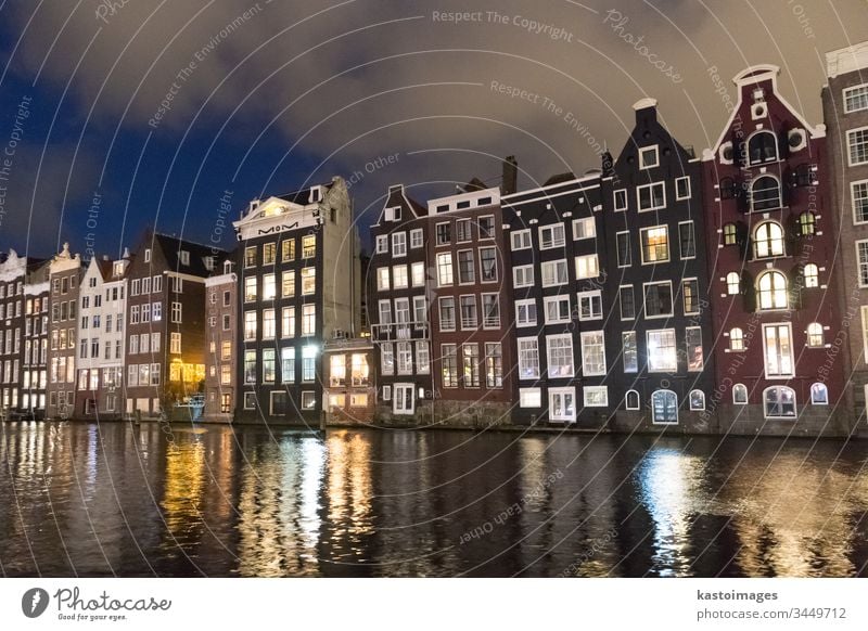 Beautiful tranquil scene of city of Amsterdam at dusk. Bicycles along the street and on the bridge over the canal. amsterdam netherlands architecture dutch