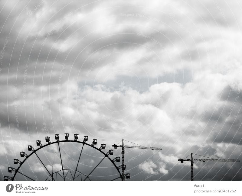 The immobilized cranes, the closed Ferris wheel, even the puffed up sky felt somehow indifferent. hustle and bustle Deserted Clouds Exterior shot Colour photo