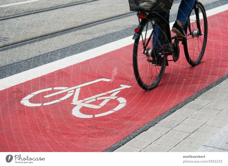 designated bike lane or cycle highway bicycle path cyclist cycling cycleway track traffic street red city symbol biking travel commute asphalt safety person