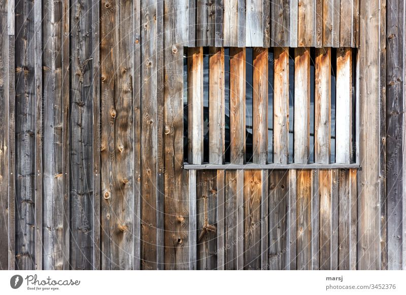 Wooden wall with a window barricaded with square timbers. Brown Wood grain Wall (building) Window Rectangle rectangular geometric Weathered Sharp-edged