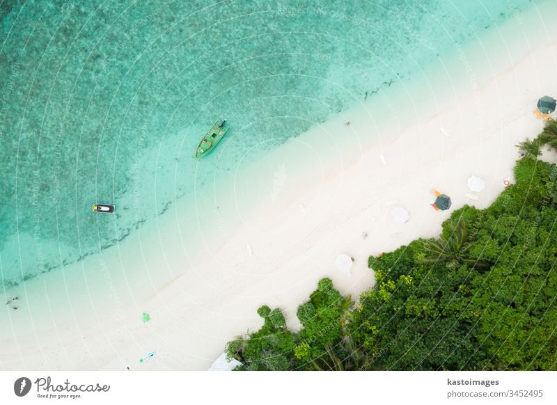 Aerial drone view of picture perfect beach and turquoise lagoon on small tropical island on Maldives ocean coast sea sand landscape nature scenery tourism