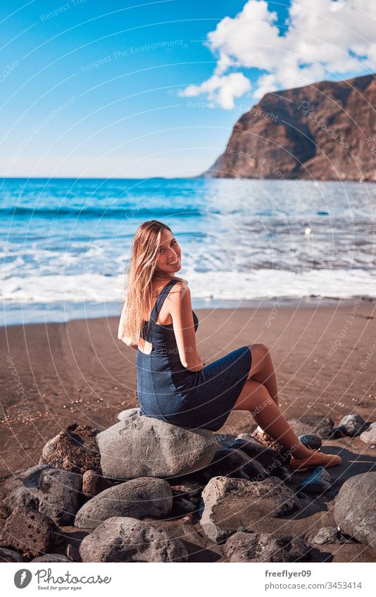 Young woman in Los Gigantes beach in Tenerife, Canary Islands, Spain alone atlantic background backward beauty blond blue canary island cliff coast coastal