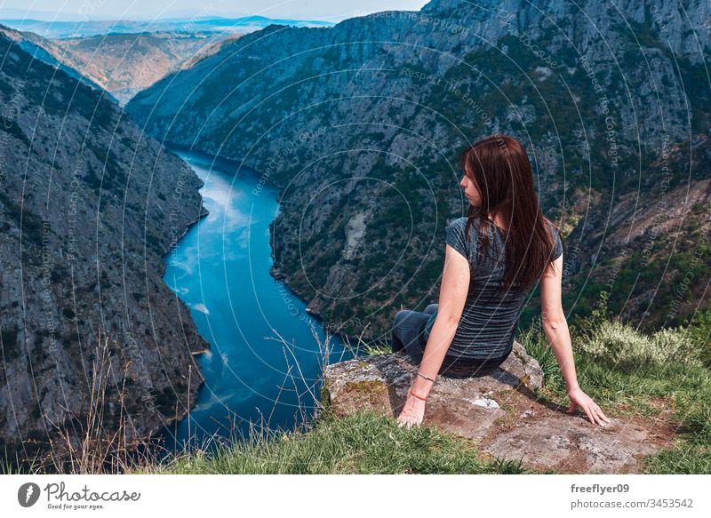 Young woman contemplating the Sil Canyons in Ourense, Spain background beautiful blue canyon cliff environment europa female forest galicia green hat hiking